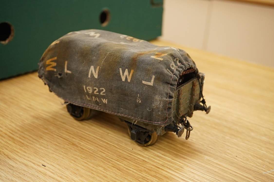 Seven Gauge One coarse scale railway freight wagons, by Bassett-Lowke, etc., including tinplate and wooden examples in liveries for LNWR, Midland Railway, and LBSCR, together with the remains of a scarce late 19th centur